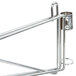 A Metro chrome wall mount shelf support post with a metal hook attached.