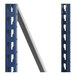 A blue rectangular Interlake Mecalux steel shelf with holes on a metal pole.