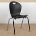A black Flash Furniture stackable classroom chair with metal legs.