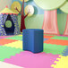 A blue moon-shaped ottoman in a colorful playroom.