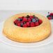 A Gobel Savarin cake with berries on top.