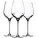 Three Stolzle Exquisit Royal white wine glasses on a white background.