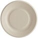A close-up of a World Centric round compostable fiber plate with a ribbed edge.