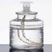 A clear plastic bottle of Sterno Soft Light clear liquid candle fuel with a white lid.