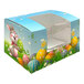 A white Easter egg candy box with a window and yellow and white polka dots with a cartoon bunny holding a colorful egg.