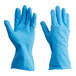 A gloved hand wearing a blue Showa 707D dishwashing glove