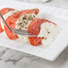 A CAC Queensquare rectangular porcelain platter with tomatoes, mozzarella, and a fork on it.