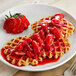 A plate of waffles topped with Oregon Fruit In Hand Strawberry Filling.