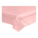A pink plastic tablecloth on a white table.