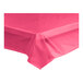 A hot pink plastic tablecloth on a table.