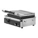 A close-up of a Vollrath stainless steel panini grill with black and silver metal plates.