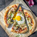 A pizza with Yo Egg plant-based sunny side up eggs and vegetables.
