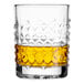 A Libbey Oracle double old fashioned glass filled with yellow liquid.