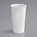 A white Solo paper hot cup on a gray background.