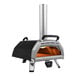 A black and silver Ooni Karu 16 outdoor pizza oven with a tall pipe.