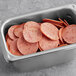 A metal tray filled with sliced Beyond Meat plant-based pepperoni.