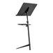 A black National Public Seating music stand with a rectangular tray on it.