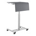 A grey National Public Seating height-adjustable mobile sit/stand desk on wheels.