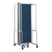 A National Public Seating blue fabric room divider on a metal cart with wheels.