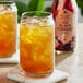 A glass of Harney & Sons Organic Black Currant Iced Tea with ice.