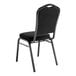 A National Public Seating black banquet chair with black seat and back.