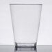 A clear plastic Fineline tall tumbler on a white surface.
