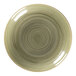 A close-up of a RAK Porcelain deep coupe plate with a green circular spiral pattern.