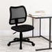 A Flash Furniture black mesh office chair with wheels next to a desk.