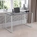 A Flash Furniture Tiverton industrial modern office desk with a laptop and phone on it.