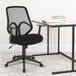 A Flash Furniture Salerno Series black mesh high-back office chair at a desk.