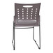 A gray Flash Furniture stack chair with a black frame and holes in the backrest.