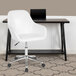 A white Flash Furniture Cortana office chair with wheels at a desk with a laptop on it.