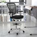 A black and white Flash Furniture Tyler mid-back drafting chair.