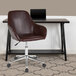 A Flash Furniture brown leather office chair with wheels at a desk with a laptop.