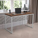 A Flash Furniture Tiverton white and wooden office desk with a laptop on it.