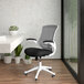 A black and white office chair with a white frame and flip up arms.