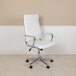 A Flash Furniture white leather office chair with ribbed details and chrome wheels and base.