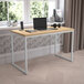 A Flash Furniture Tiverton industrial modern office desk in maple and white with a laptop on it.