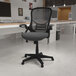 A Flash Furniture Porter dark gray mesh high-back office chair with flip-up arms.