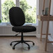 A Flash Furniture black fabric office chair with wheels at a wooden desk.