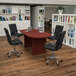 A Flash Furniture oval conference table with black chairs around it.