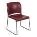A Flash Furniture burgundy stack chair with metal legs.