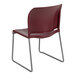 A burgundy Flash Furniture stack chair with metal legs.