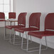 A row of Flash Furniture burgundy chairs with a gray base.