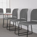 A row of Flash Furniture gray chairs in a room.