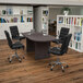 A Flash Furniture Lake Rustic Gray oval conference table with four black leather chairs.