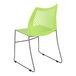 A green plastic Flash Furniture Hercules banquet chair with metal legs.