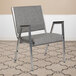 A Flash Furniture gray bariatric reception arm chair with metal arms and legs.