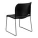 A black Flash Furniture stacking chair with a gray metal sled base.