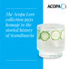 A clear, textured 10 oz. rocks or old fashioned glass from the Acopa Lore collection, shown with a beverage and cucumber slices inside.